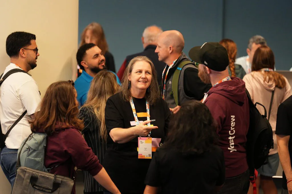 People chatting at a conference networking event.